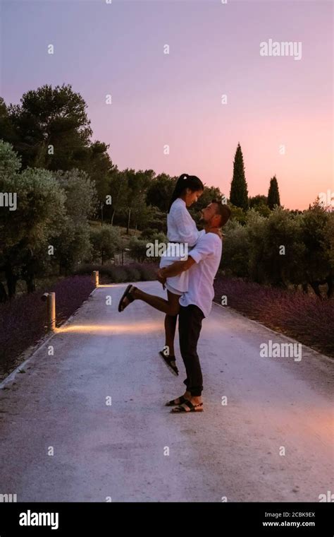 couple walking path with lavender during sunset in the Provence France ...