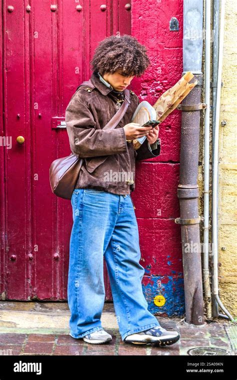 Man checking phone standing in hi-res stock photography and images - Alamy