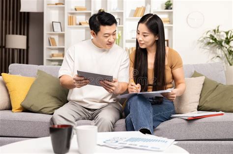 Couple Discussing Finances with Tablet and Documents at Home Stock Image - Image of relationship ...