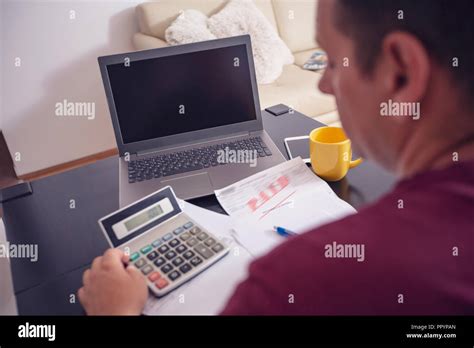 Young man planning family budget and finances at home Stock Photo - Alamy