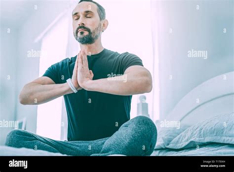 Inspired relaxed man meditating in a light room Stock Photo - Alamy