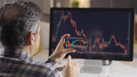 Man searching and analyzing stock market data. The trader looks and ...