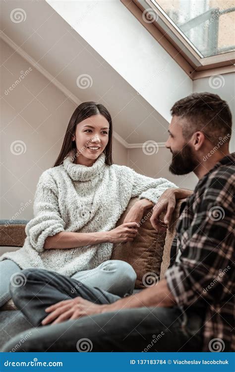 Positive Nice Young Couple Having a Conversation Stock Photo - Image of attic, emotion: 137183784
