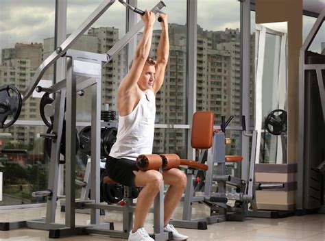 Premium Photo | Sporty young man training in gym
