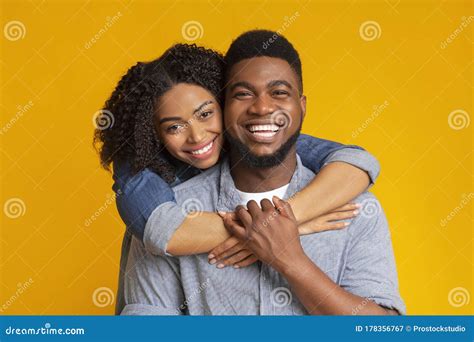 Happy Together. Family Portrait of Smiling Black Couple Hugging, Yellow ...