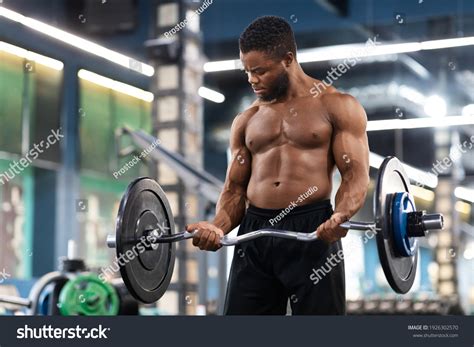 Men Lifting Weights At The Gym
