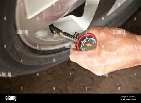 Checking the tire pressure Stock Photo - Alamy