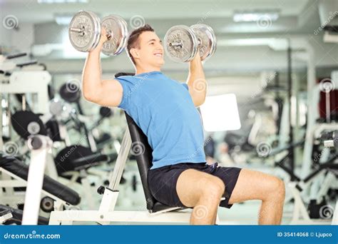 Smiling Muscular Guy Lifting Weights In Gym Club Royalty Free Stock ...