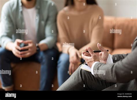 Couple talking at session with male therapist Stock Photo - Alamy