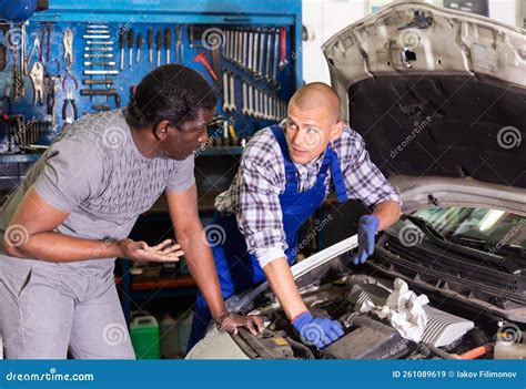 Two Car Mechanic Diagnosing Auto Engine Problem in Service Stock Image ...