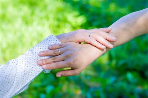 Premium Photo | Close up of couple hold hands talking sharing secrets showing love and care ...