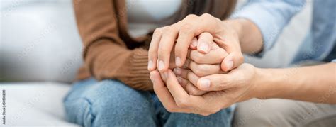 Couples hold hands to support each other while discussing family issues ...