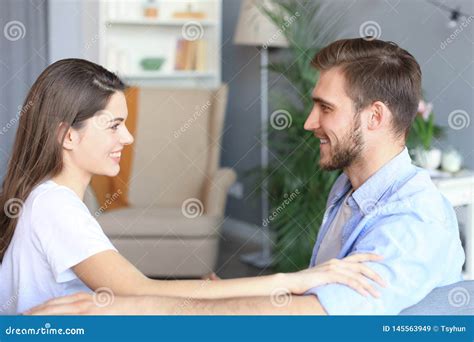 Side View of a Couple Talking Sitting on a Couch and Looking Each Other ...