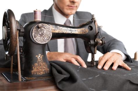 Premium Photo | Tailor at work confident young tailor sewing clothes at ...