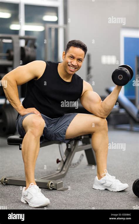cheerful man lifting weights at gym Stock Photo - Alamy