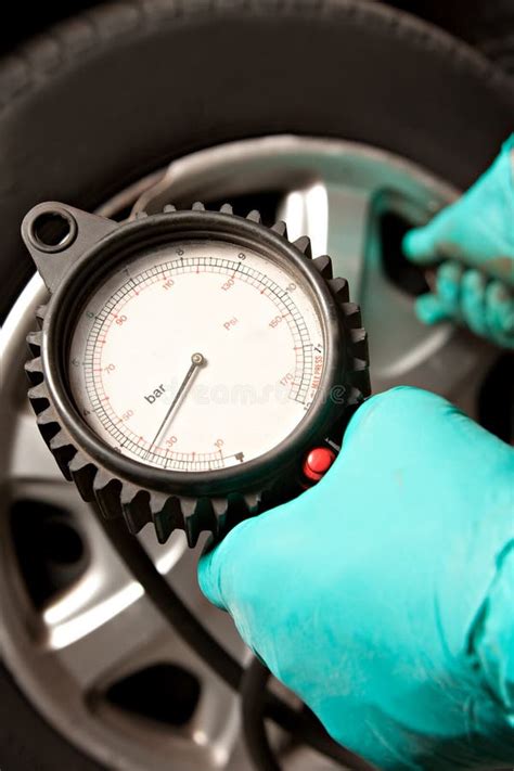 Car Tire Pressure Check in the Auto Service Garage. Checking and ...