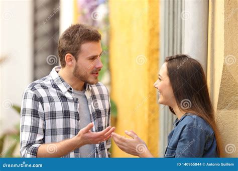 Couple Talking Standing in a Colorful Street Stock Photo - Image of ...