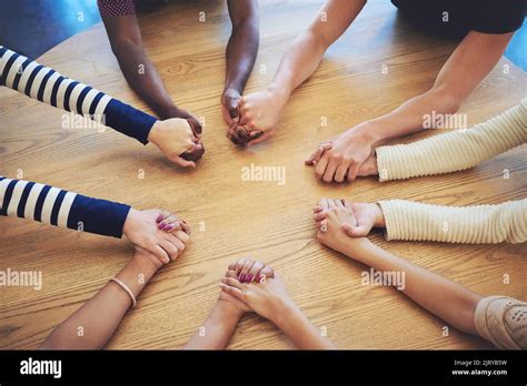 Friends support each other no matter what. a group of unidentifiable friends joining their hands ...