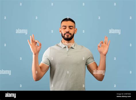 Stress relief concept. Middle eastern man meditating with closed eyes ...