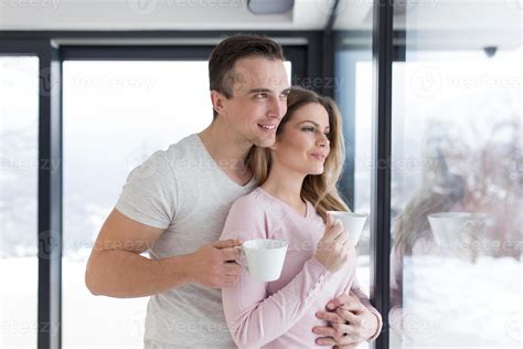 young couple enjoying morning coffee by the window 10357597 Stock Photo ...