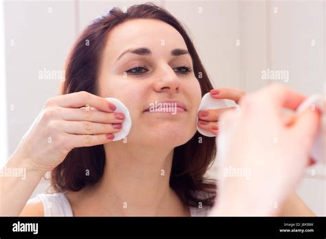 Applying makeup in bathroom mirror hi-res stock photography and images ...