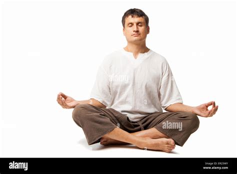 Peaceful man doing yoga and meditating - isolated over a white ...