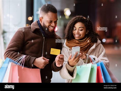 Couple using mobile bank card hi-res stock photography and images - Alamy