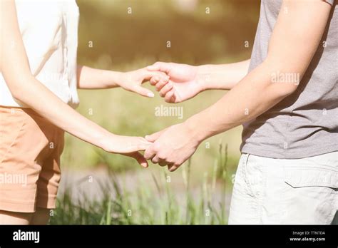 Couple holding hands, close up Stock Photo - Alamy