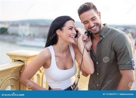 Happy Young Couple Listening Music Outdoors Stock Image - Image of ...