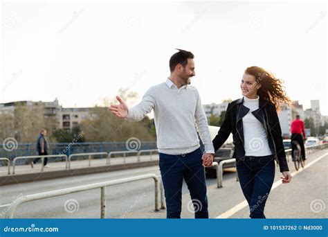 Happy Young Couple Walking Hand in Hand Stock Photo - Image of holding ...