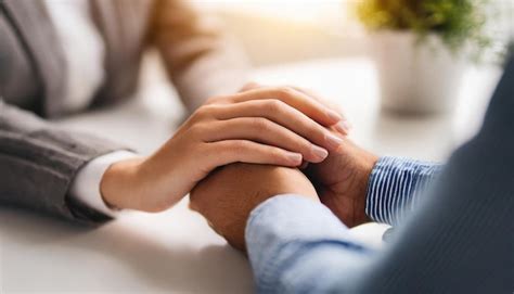 Premium Photo | Two hands gently holding each other symbolizing support ...