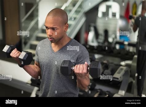 Black man lifting weights in gym Stock Photo - Alamy