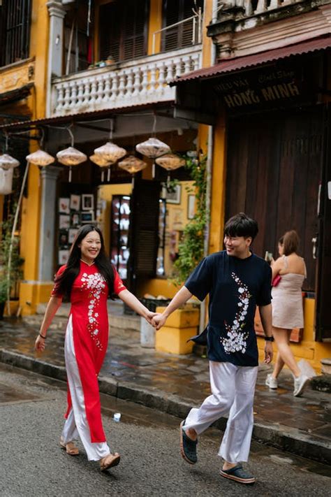 Photo of a Couple Walking while Holding Hands · Free Stock Photo