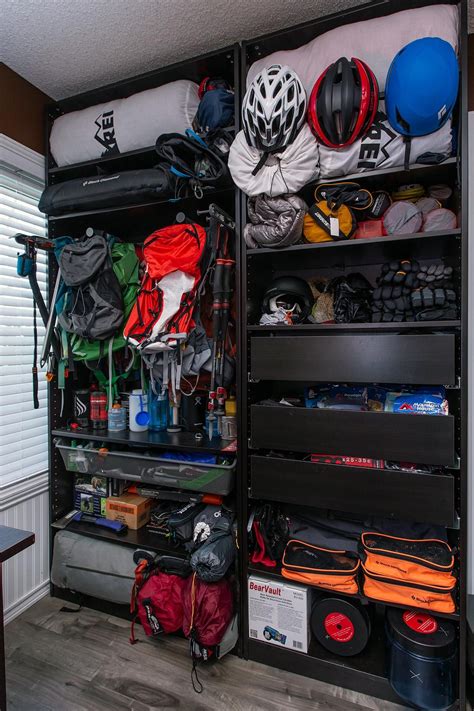 the inside of a bicycle storage unit with helmets and bags on it's shelves