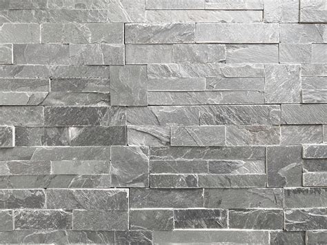 Seamless texture of white grey brick stone wall a rough surface, with ...