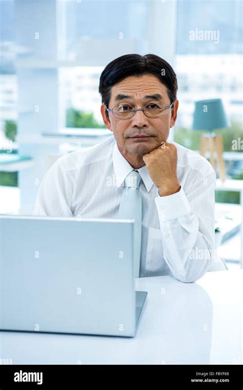 Asian man serious looking at camera hi-res stock photography and images ...