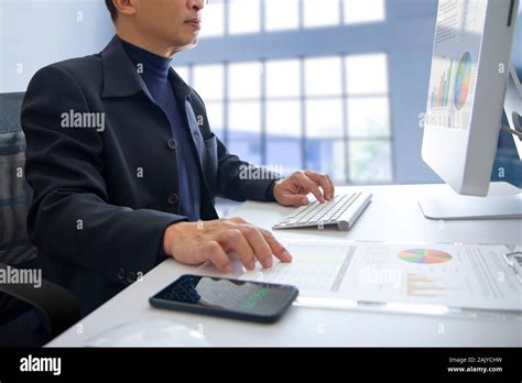 Businessmen reviewing financial statements for annual business ...