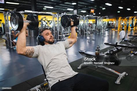 Young Man Lifting Heavy Weights At The Gym Stock Photo - Download Image ...