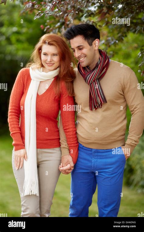 Happy couple walking together Stock Photo - Alamy