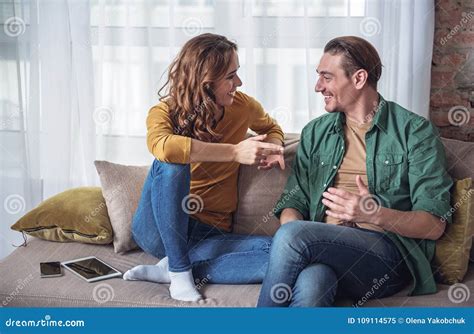 Glad Married Couple Talking in Living Room Stock Image - Image of love, hold: 109114575
