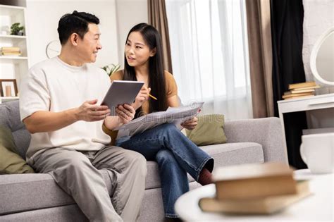 Happy Couple Planning Finances with Tablet at Home Stock Photo - Image ...