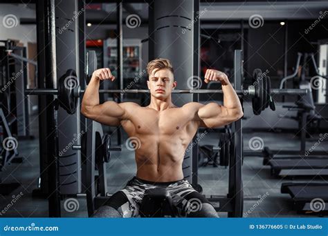 Close Up of a Muscular Young Man Lifting Weights in Gym on Dark ...