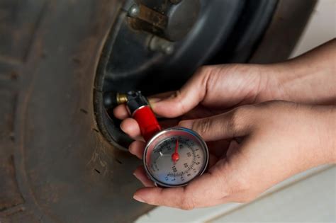 Premium Photo | Cropped hands of man checking air pressure of car tire