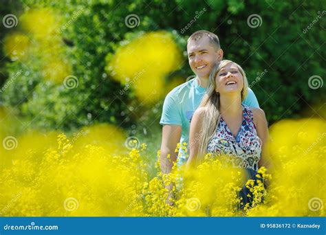 Happy Couple in Yellow Field. Stock Photo - Image of adult, groom: 95836172