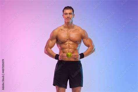 Happy man athlete with dumbbell isolated on pink background. Gym full ...