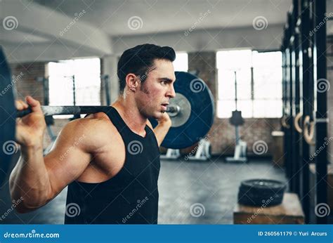 Focused on His Fitness Goals. a Man Lifting Weights at the Gym. Stock ...