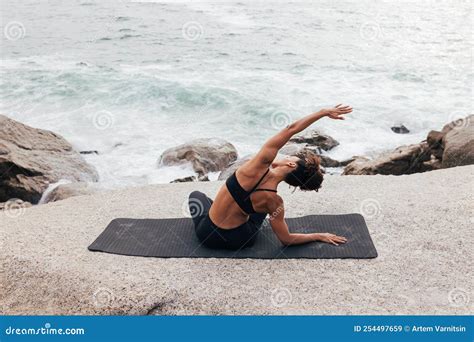 Muscular Woman Stretching on Mat by Ocean. Fit Female Doing Flexibility ...