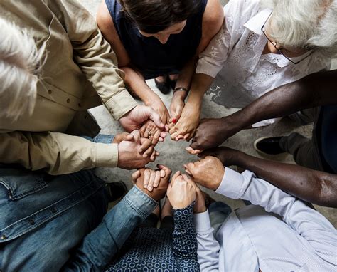Group of diverse hands holding each other support together teamwork ...