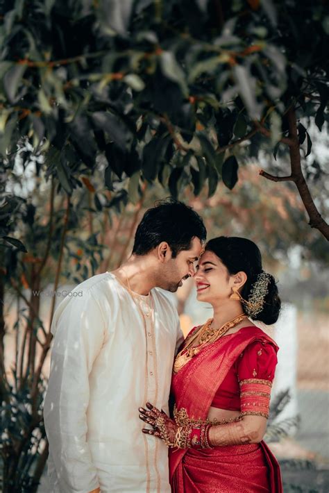 Photo of cute south indian couple shot with bride in red saree