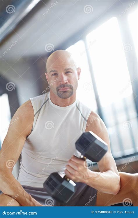 Focusing on those Muscles. an Serious Man Lifting Weights in a the Gym ...